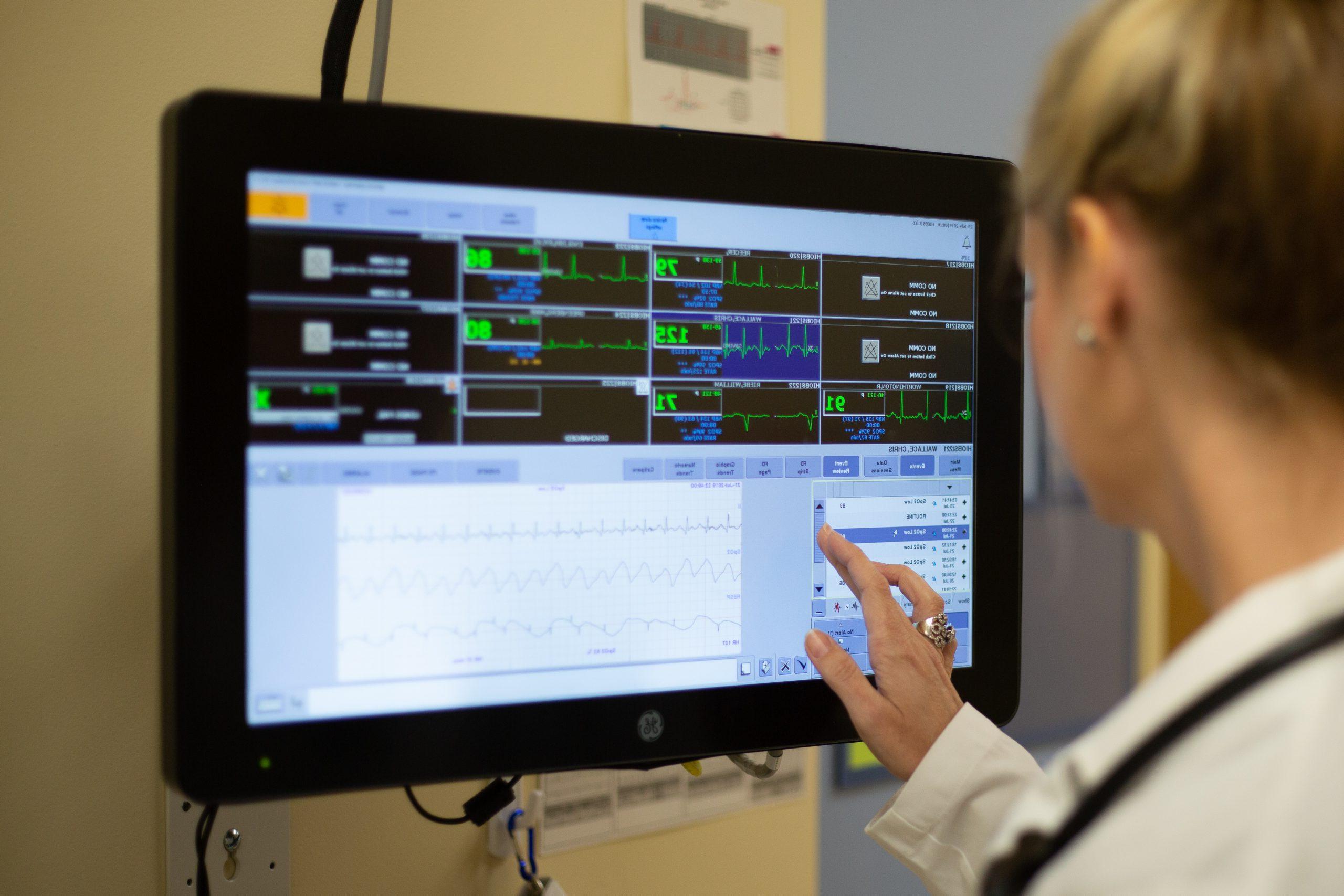 female student looking at vitals on a screen